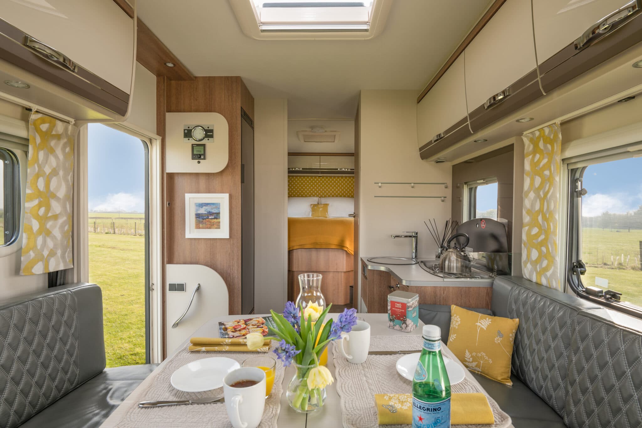 Glamper interior lounge and kitchen with dining table laid for breakfast